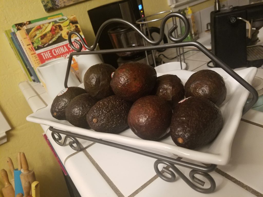 avocados in a white metal tray