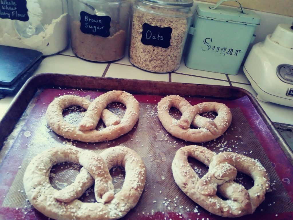 four pretzels on a baking sheet