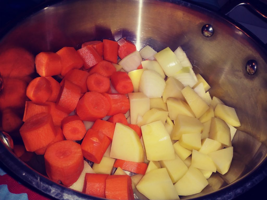 Carrots and potatoes in pot for cheese sauce