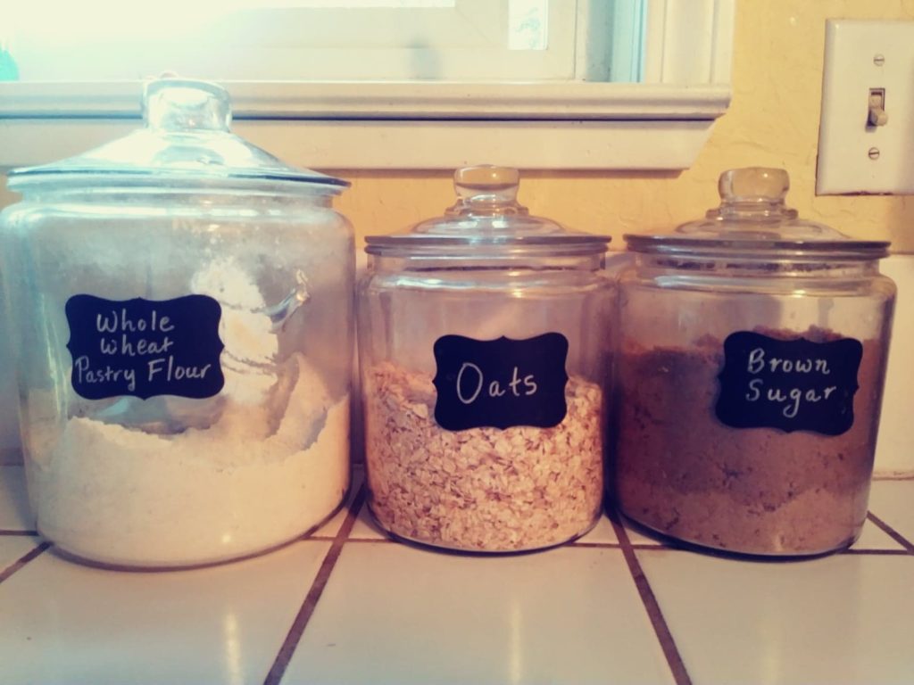 Glass canisters with flour, oats and brown sugar