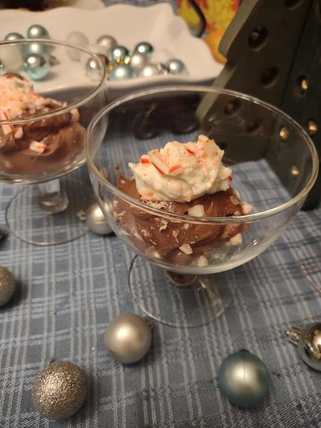 tofu chocolate mousse topped with coconut cream and peppermint, Christmas ornaments on table