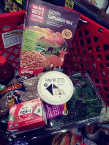 Grocery Outlet cart with Mom's cereal, Kite Hill cream cheese, silken tofu, lentils and salad pak