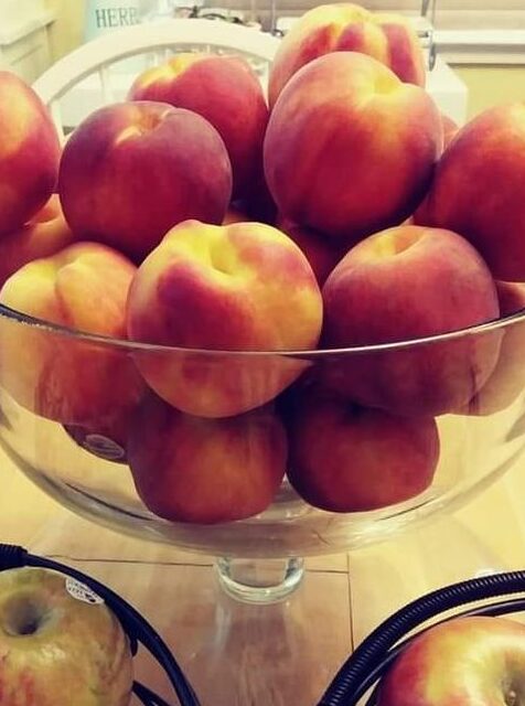 Peaches in a glass pedestal bowl