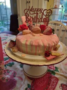 Homemade vegan birthday cake decorated with pink drip frosting