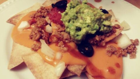 Homemade nachos with cheese sauce, TVp taco meat, baked chips, salsa