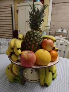 fruit display on my table with pineapples, bananas, apples, oranges, grapefruit