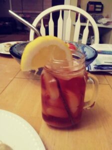 iced tea with lemon slice homemade in a mason jar cup