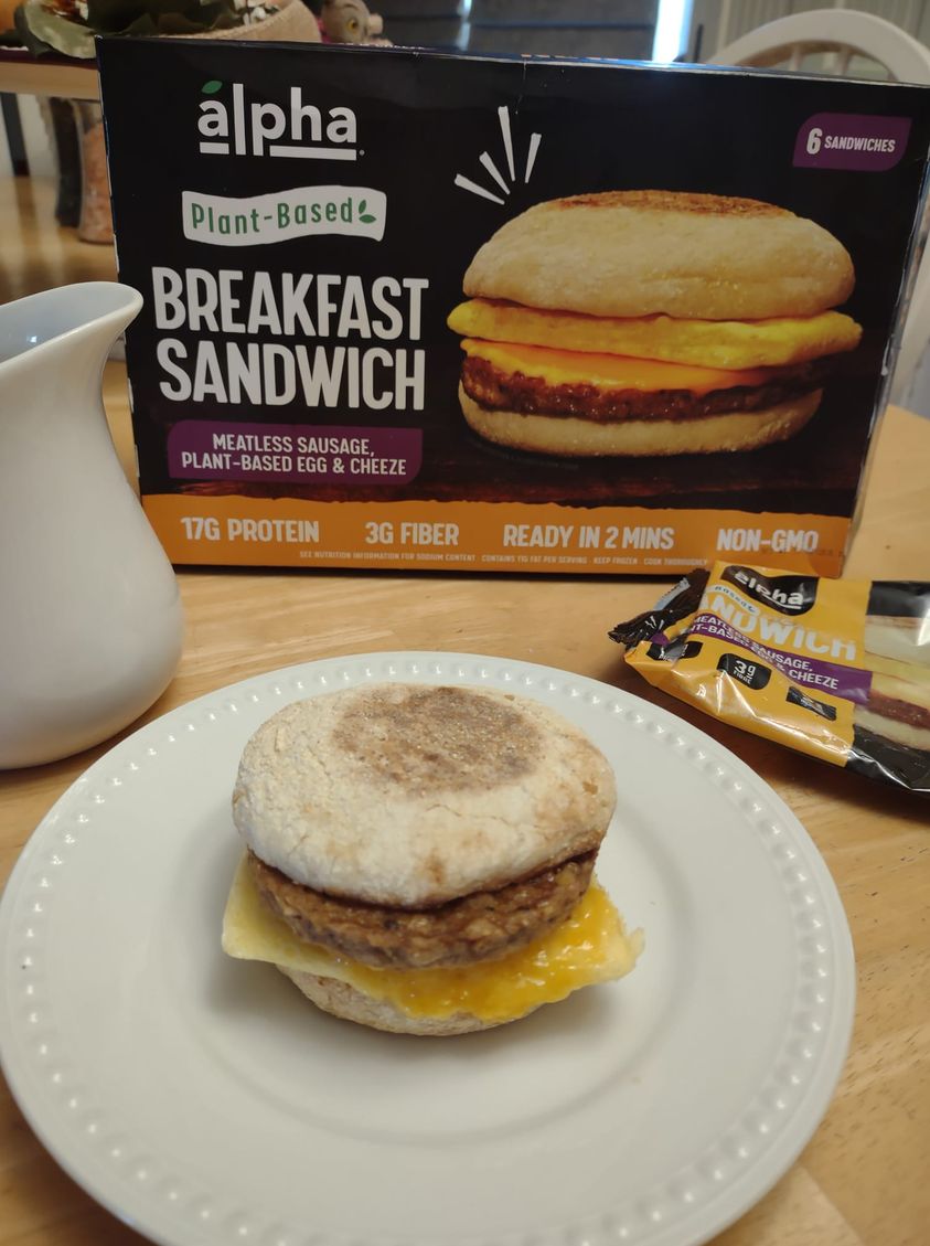 Alpha breakfast sandwich on plate and box behind