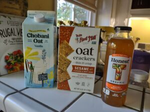 Chobani oatmilk, ob's oat crackers and bottle of Honest Tea