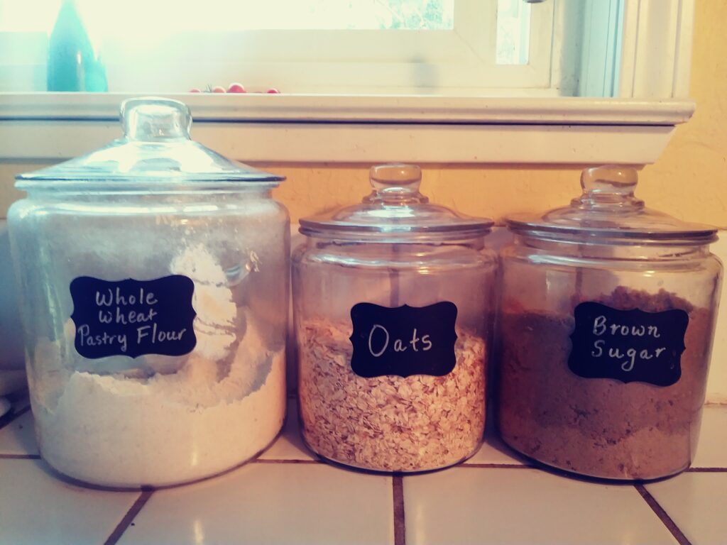 my glass canister with chalkboard labels marked whole wheat pastry flour, oats and brown sugar