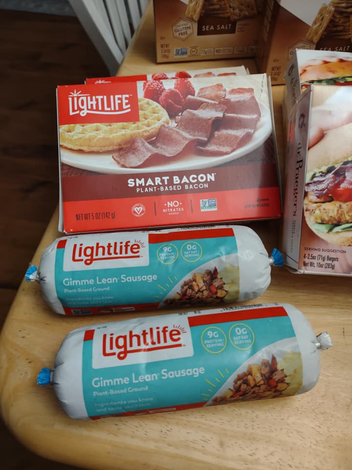 Lightlife sausage tubes and packs of bacon on my kitchen tablen