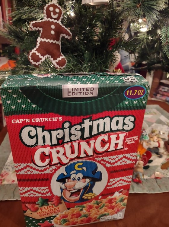 box of Cap'n Crunch Christmas Crunch next to my Chritmas tree and gingerbread man ornament