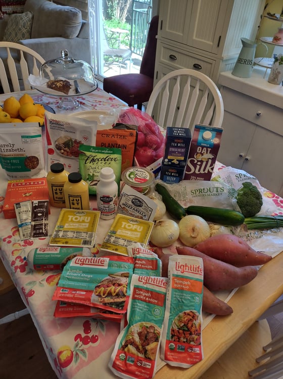 Sprouts $22 Trip laid out on my kitchen table, products and prices detailed in this post