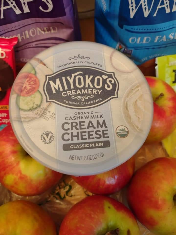 Miyoko's original cream cheese tub on top of apples