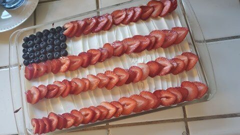 Flag cake I made with white cake, white frosting ans strawberries and blueberries to look like a United States flag