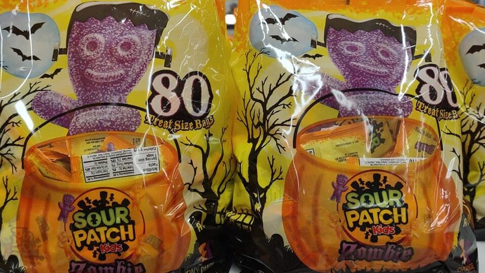 Large bags of Sour Patch Halloween candy marked $10.99