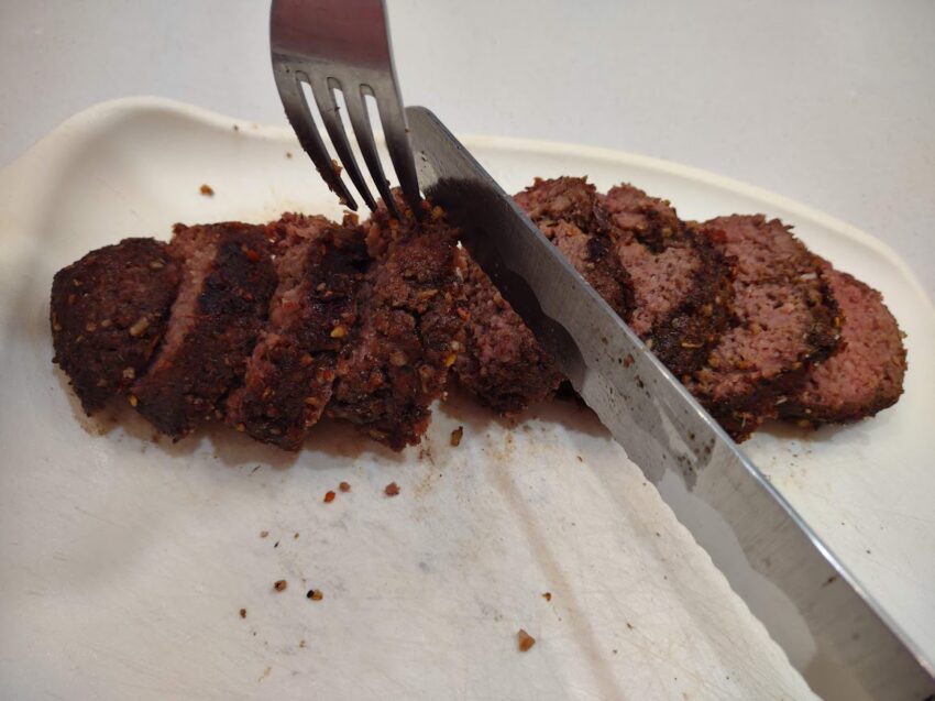 sliced vegan steak with carving knife and fork