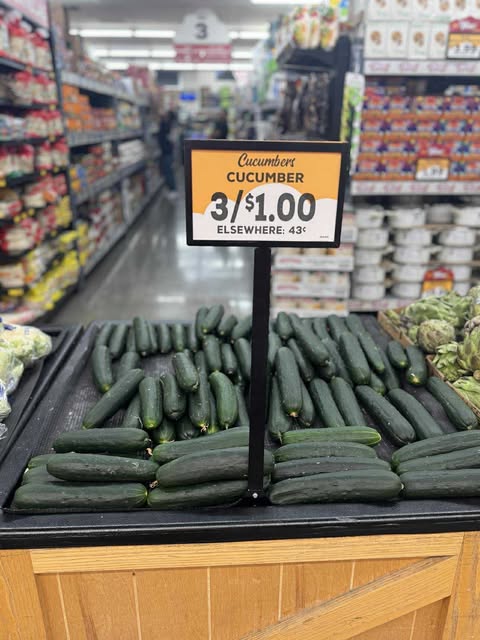 cucumbers display with 3/$1 sign at Grocery Outlet
