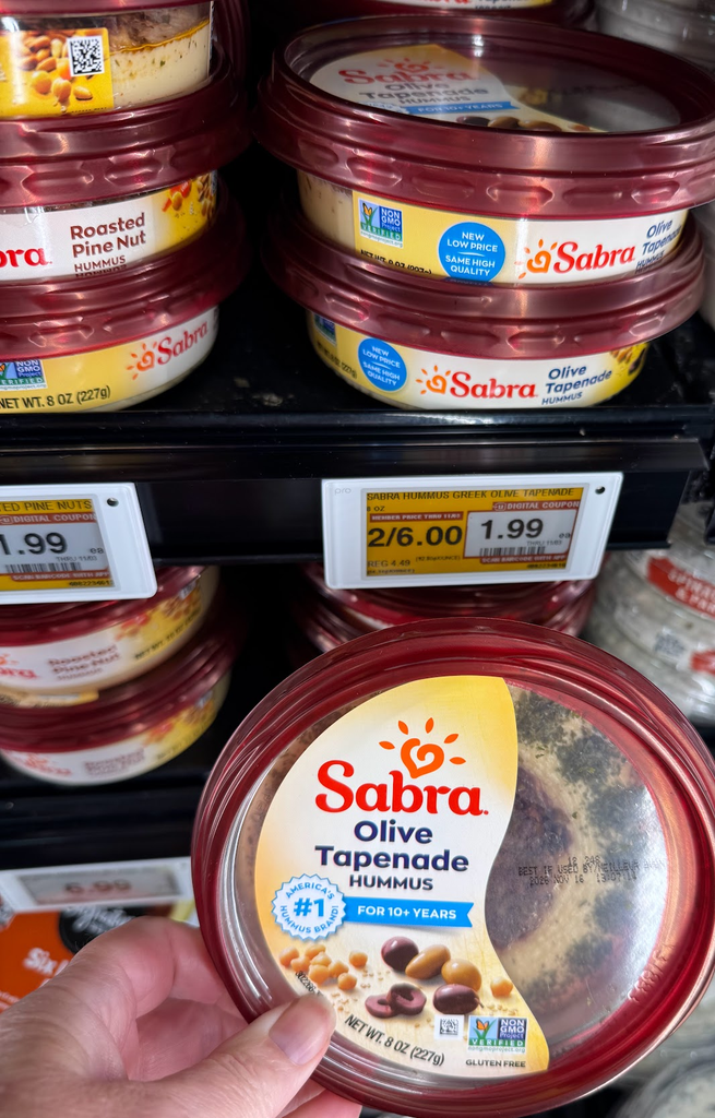 Holding Sabra Hummus Olive Tapenade Closeup